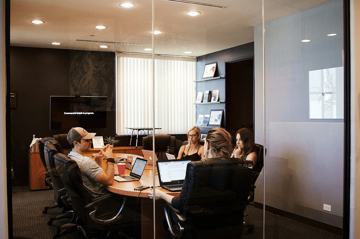 People sitting near table with laptop computer photo