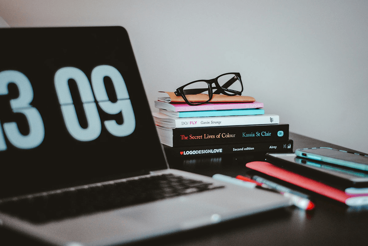 silver macbook pro near books